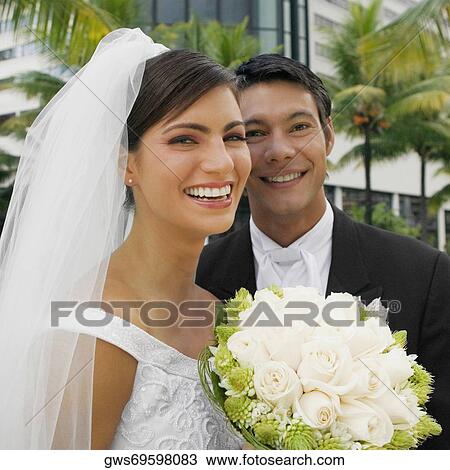 Close-up of a newlywed couple smiling View Large Photo Image Stock Image - Close-up of a newlywed couple smiling. Fotosearch