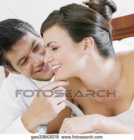 Close-up of a newlywed couple smiling View Large Photo Image Stock Photo - Close-up of a newlywed couple smiling. Fotosearch