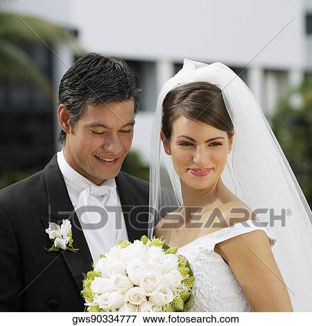 Close-up of a newlywed couple smiling View Large Photo Image Stock Photo - Close-up of a newlywed couple smiling. Fotosearch