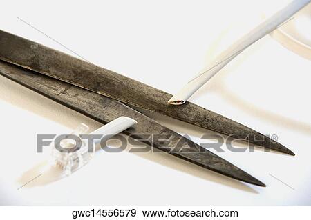 Close-up of a pair of scissors cutting a cable View Large Photo Image Stock Photo - Close-up of a pair of scissors cutting a cable. Fotosearch