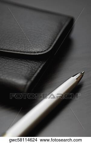 Close-up of a pen and a wallet View Large Photo Image Picture - Close-up of a pen and a wallet. Fotosearch