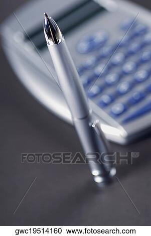 Close-up of a pen with a calculator View Large Photo Image Stock Image - Close-up of a pen with a calculator. Fotosearch