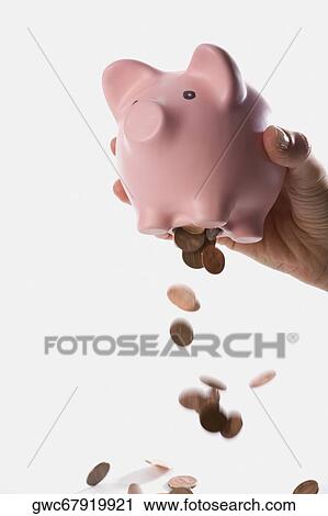 Close-up of a person dropping coins from a piggy bank View Large Photo Image Stock Image - Close-up of a person dropping coins from a piggy bank. Fotosearch