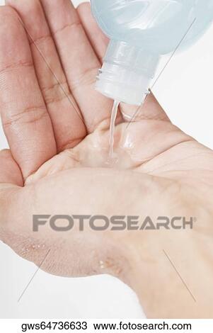 Close-up of a person pouring moisturizer View Large Photo Image Stock Image - Close-up of a person pouring moisturizer. Fotosearch