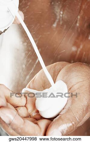 Close-up of a person pouring shampoo in his hand View Large Photo Image Stock Photo - Close-up of a person pouring shampoo in his hand. Fotosearch