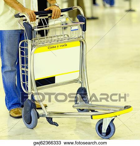 Close-up of a person standing with a luggage cart View Large Photo Image Stock Image - Close-up of a person standing with a luggage cart. Fotosearch