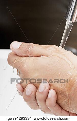 Close-up of a person washing hands View Large Photo Image Picture - Close-up of a person washing hands. Fotosearch