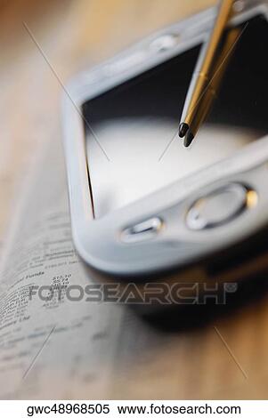 Stock Photography - Close-up of a personal data assistant with a digitized pen. Fotosearch