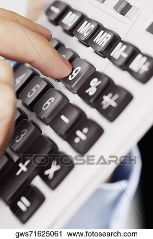 Close-up of a person's finger pressing the buttons of a calculator View Large Photo Image Stock Image - Close-up of a person's finger pressing the buttons of a calculator. Fotosearch