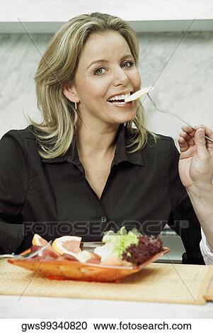 Close-up of a person's hand feeding fruit salad to a mid adult woman View Large Photo Image Stock Image - Close-up of a person's hand feeding fruit salad to a mid adult woman. Fotosearch