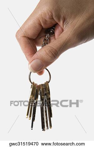 Stock Image - Close-up of a person's hand holding a key ring. Fotosearch