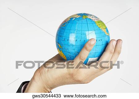 Close-up of a person's hand holding a globe View Large Photo Image Stock Image - Close-up of a person's hand holding a globe. Fotosearch