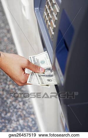 Close-up of a person's hand receiving one hundred dollar bills from an ATM View Large Photo Image Stock Photo - Close-up of a person's hand receiving one hundred dollar bills from an ATM. Fotosearch