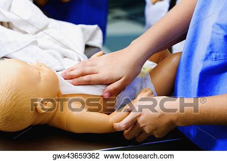 Close-up of a person's hand wiping a doll with a tissue paper View Large Photo Image Stock Image - Close-up of a person's hand wiping a doll with a tissue paper. Fotosearch