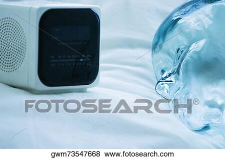 Stock Photo - Close-up of a radio near a glass statue. Fotosearch