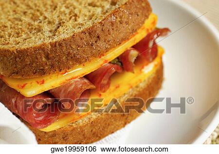 Close-up of a roast beef and cheese sandwich on a plate View Large Photo Image Stock Photograph - Close-up of a roast beef and cheese sandwich on a plate. Fotosearch