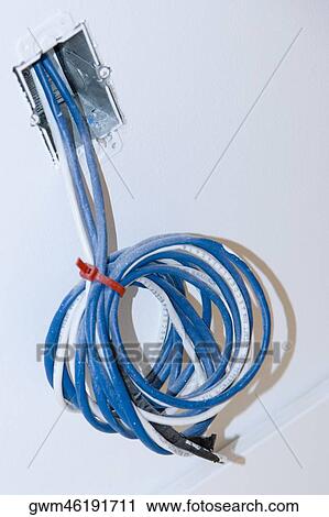 Close-up of a roll of cables coming out from a wall View Large Photo Image Stock Image - Close-up of a roll of cables coming out from a wall. Fotosearch