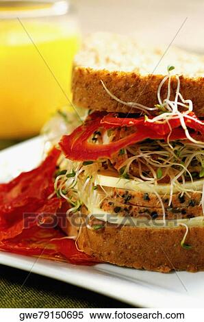 Close-up of a sandwich with a glass of juice View Large Photo Image Stock Photography - Close-up of a sandwich with a glass of juice. Fotosearch