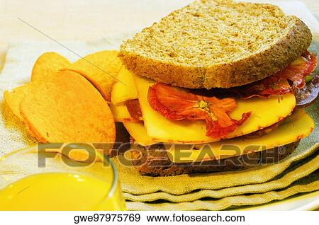 Close-up of a sandwich with potato chips on a napkin View Large Photo Image Stock Photo - Close-up of a sandwich with potato chips on a napkin. Fotosearch