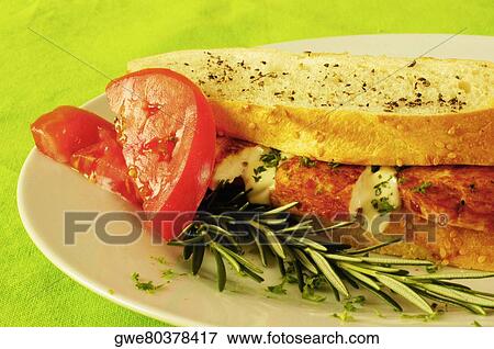 Stock Photo - Close-up of a sandwich with tomato slices on a plate. Fotosearch
