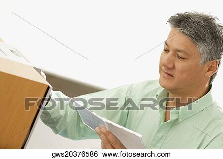 Close-up of a senior man holding a CD Case View Large Photo Image Stock Photograph - Close-up of a senior man holding a CD Case. Fotosearch