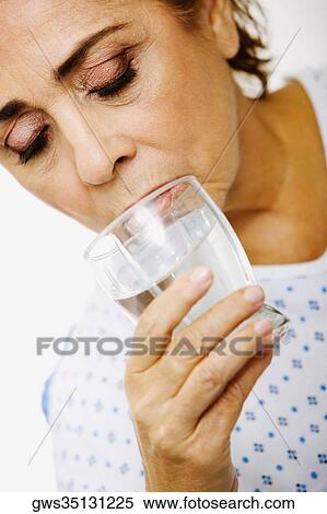 Close-up of a senior woman drinking water from a glass View Large Photo Image Stock Photography - Close-up of a senior woman drinking water from a glass. Fotosearch