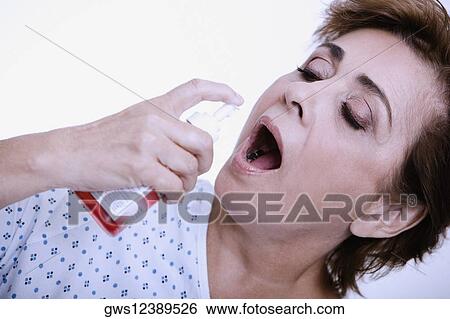 Close-up of a senior woman spraying mouthwash into her mouth View Large Photo Image Stock Photograph - Close-up of a senior woman spraying mouthwash into her mouth. Fotosearch