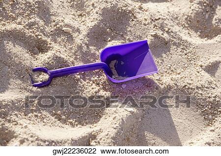 Close-up of a shovel in sand View Large Photo Image Stock Image - Close-up of a shovel in sand. Fotosearch