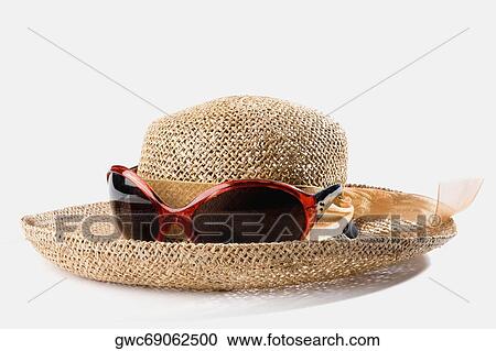 Close-up of a straw hat with sunglasses View Large Photo Image Stock Image - Close-up of a straw hat with sunglasses. Fotosearch