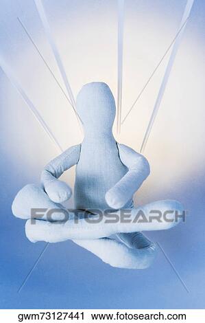 Stock Image - Close-up of a stuffed toy sitting with cross-legged. Fotosearch