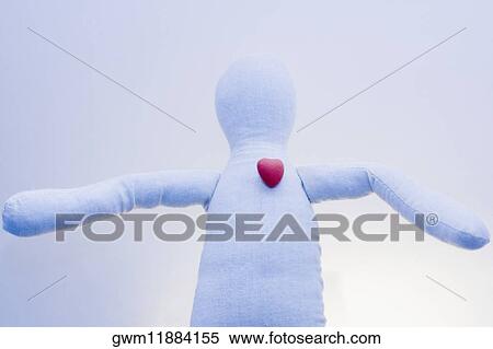 Stock Photography - Close-up of a stuffed toy with a heart shaped candy on it. Fotosearch
