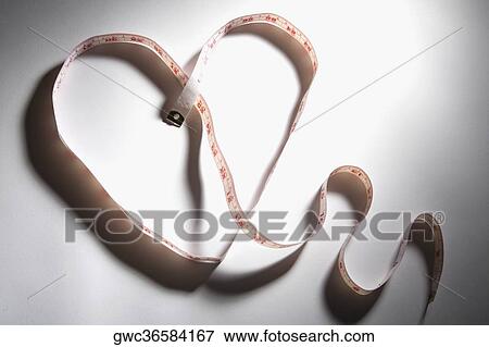 Close-up of a tape measure in the shape of a heart View Large Photo Image Stock Photo - Close-up of a tape measure in the shape of a heart. Fotosearch
