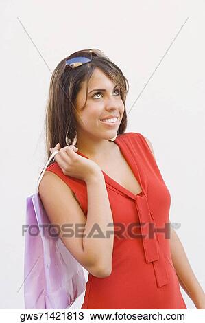 Stock Image - Close-up of a teenage girl holding a shopping bag. Fotosearch