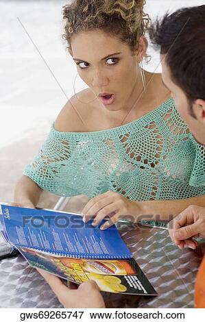 Close-up of a teenage girl looking at a mid adult man in amazement View Large Photo Image Stock Photo - Close-up of a teenage girl looking at a mid adult man in amazement. Fotosearch