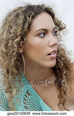 Close-up of a teenage girl looking away View Large Photo Image Stock Photo - Close-up of a teenage girl looking away. Fotosearch