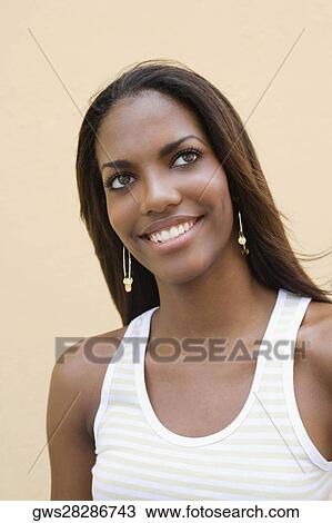 Close-up of a teenage girl looking cheerful View Large Photo Image Stock Image - Close-up of a teenage girl looking cheerful. Fotosearch