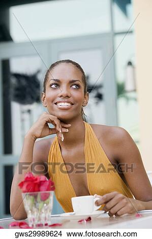 Picture - Close-up of a teenage girl sitting in a restaurant with a cup of coffee . Fotosearch