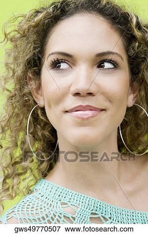 Close-up of a teenage girl smiling and looking away View Large Photo Image Stock Photo - Close-up of a teenage girl smiling and looking away. Fotosearch
