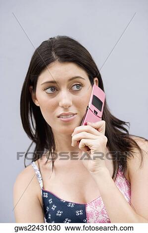 Close-up of a teenage girl using a mobile phone and looking away View Large Photo Image Stock Image - Close-up of a teenage girl using a mobile phone and looking away. Fotosearch