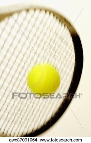 Close-up of a tennis ball with a tennis racket View Large Photo Image Picture - Close-up of a tennis ball with a tennis racket. Fotosearch