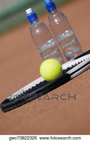 Close-up of a tennis racket and a tennis ball with two water bottles View Large Photo Image Stock Photograph - Close-up of a tennis racket and a tennis ball with two water bottles. Fotosearch