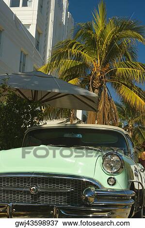 Close-up of a vintage car parked in front of a building View Large Photo Image Stock Photo - Close-up of a vintage car parked in front of a building. Fotosearch