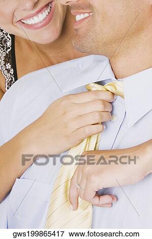 Close-up of a woman adjusting a man's tie View Large Photo Image Stock Photo - Close-up of a woman adjusting a man's tie. Fotosearch