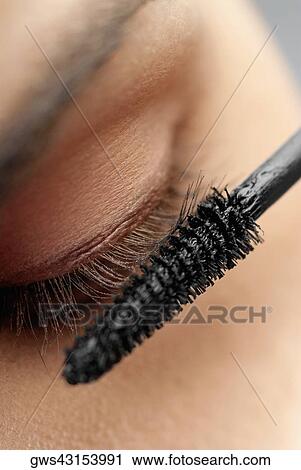 Close-up of a woman applying mascara View Large Photo Image Stock Image - Close-up of a woman applying mascara. Fotosearch