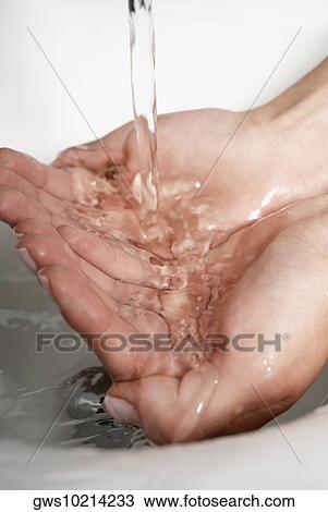 Close-up of a woman washing her hands in the bathroom sink View Large Photo Image Stock Image - Close-up of a woman washing her hands in the bathroom sink. Fotosearch