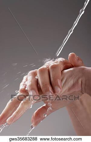 Stock Photo - Close-up of a woman washing her hands. Fotosearch