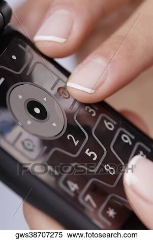 Close-up of a woman's finger using a mobile phone View Large Photo Image Stock Photography - Close-up of a woman's finger using a mobile phone. Fotosearch