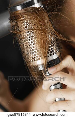 Close-up of a woman's hand brushing her hair View Large Photo Image Picture - Close-up of a woman's hand brushing her hair. Fotosearch