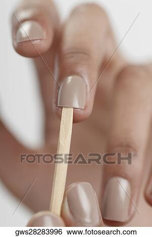 Close-up of a woman's hand giving herself a manicure View Large Photo Image Stock Photograph - Close-up of a woman's hand giving herself a manicure. Fotosearch