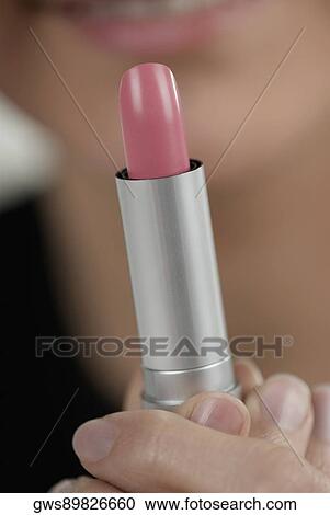 Close-up of a woman's hand holding a lipstick View Large Photo Image Stock Image - Close-up of a woman's hand holding a lipstick. Fotosearch
